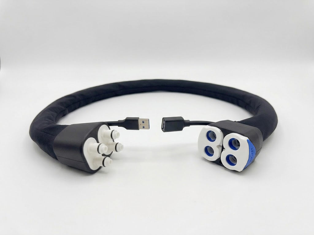 A water and data extension hose compatible with the Eight Sleep Pod. Plastic fittings at both ends for water flow, as well as a USB extension cable. The tubing of the unit is wrapped in a soft black fabric.